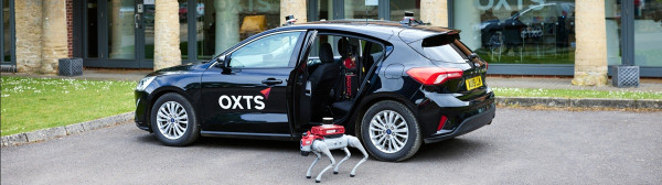 WayFinder Hub on a car with WayFinder Prime on a robot dog outside the OXTS offices